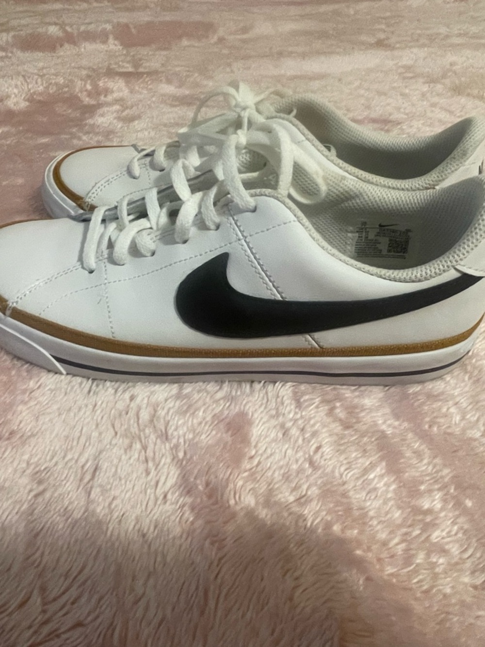 Nike White Low-Top Sneakers with Black Swoosh and Gold Trim